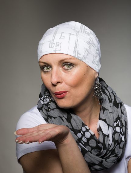 Portrait of beautiful positive smiling middle age woman patient with cancer wearing headscarf, hope in healing